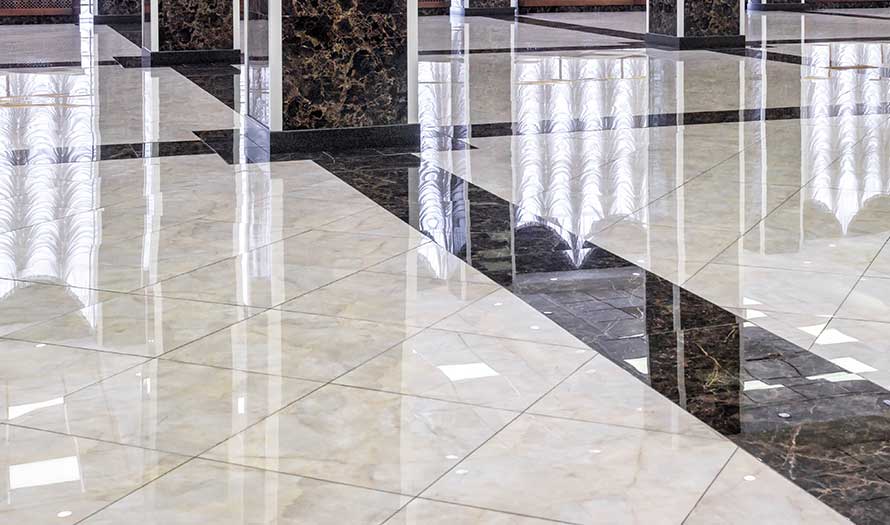 A broad image of a gleaming Marble floor in a hotel's luxurious foyer.